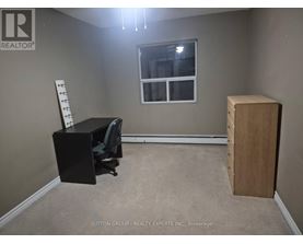 A room with a desk, chair, and a window.