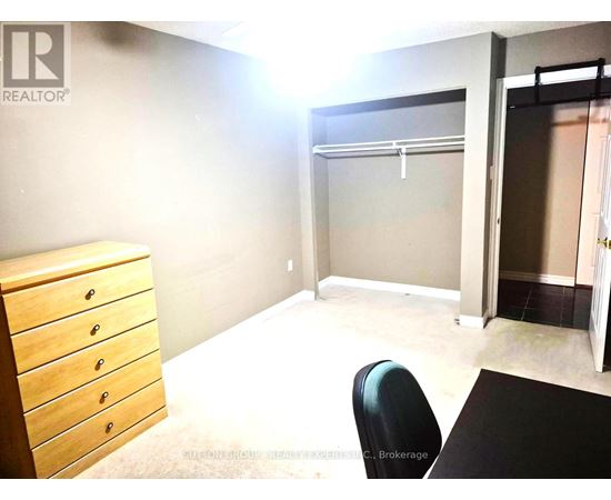 A room with a desk, chair, and a window.