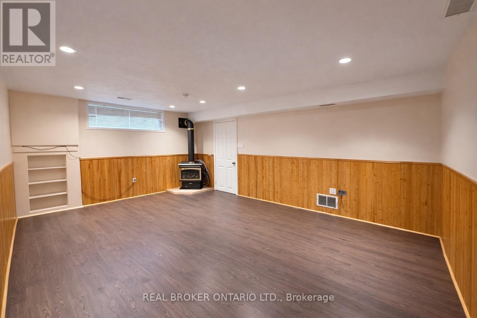 A spacious room with a staircase leading to the upper floor.