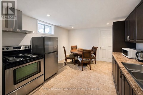 A kitchen with a table and chairs in the middle of the room.