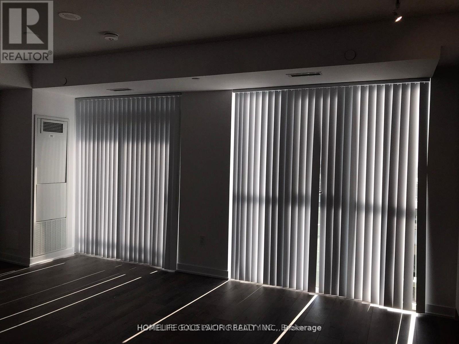 A room with a sliding door and wooden flooring.