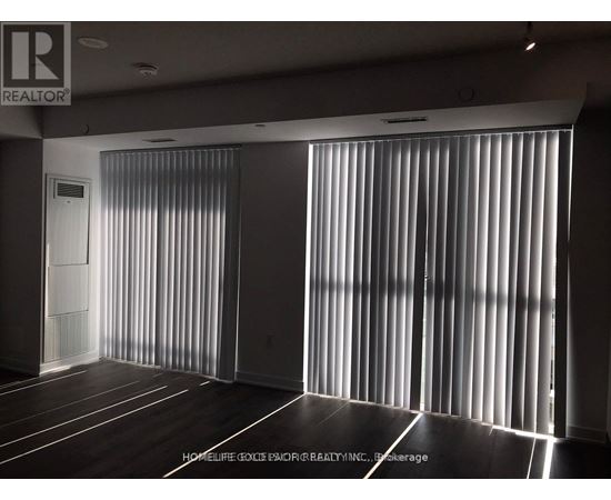 A room with a sliding door and wooden flooring.