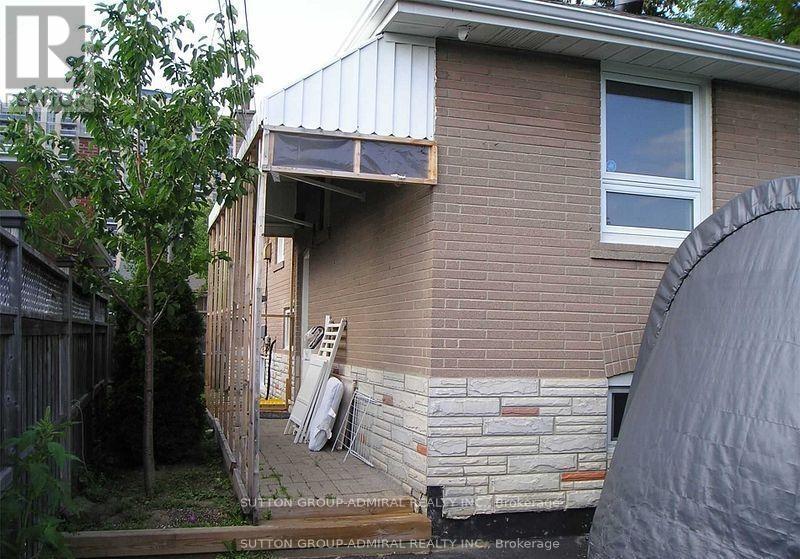 A house with a brick wall and a window.