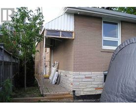 A house with a brick wall and a window.