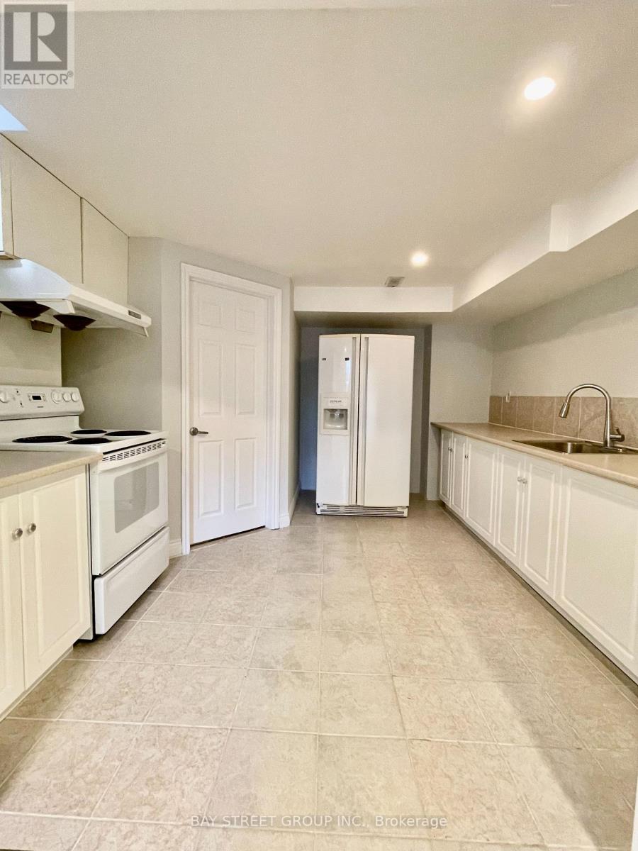 A kitchen with white appliances and cabinets.