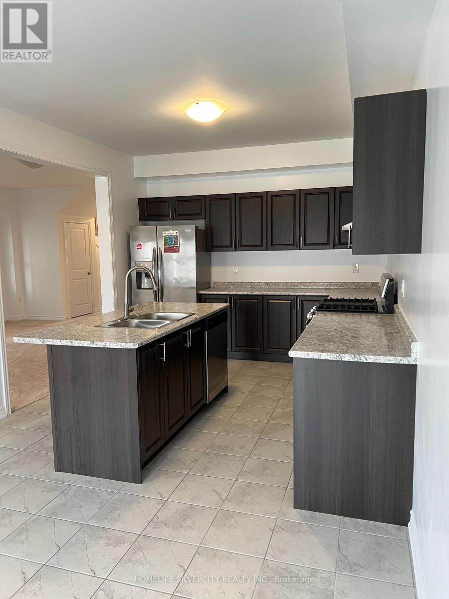 A kitchen with black cabinets and a marble countertop.