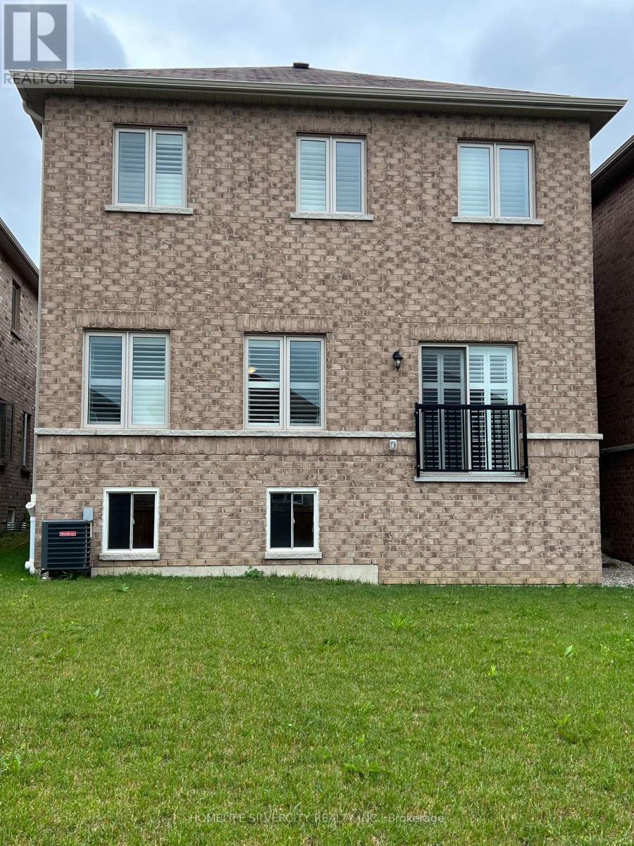 A brick building with a balcony on the second floor.