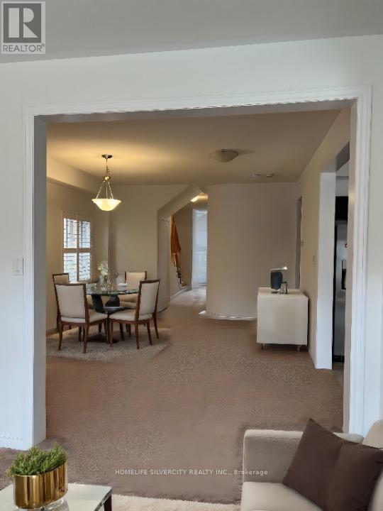 A living room with a dining table and chairs.
