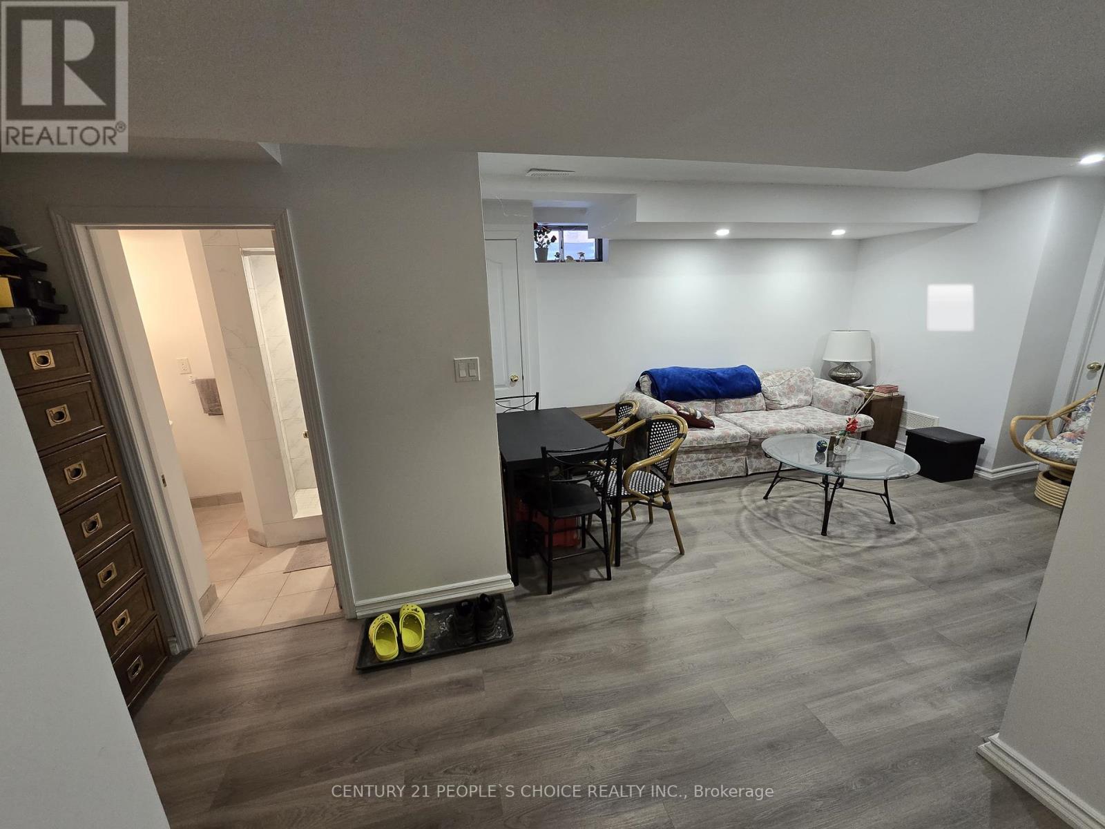 A living room with a TV on the wall and a couch.