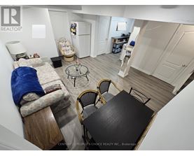 A small, messy bedroom with a table and chairs.