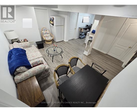 A small, messy bedroom with a table and chairs.