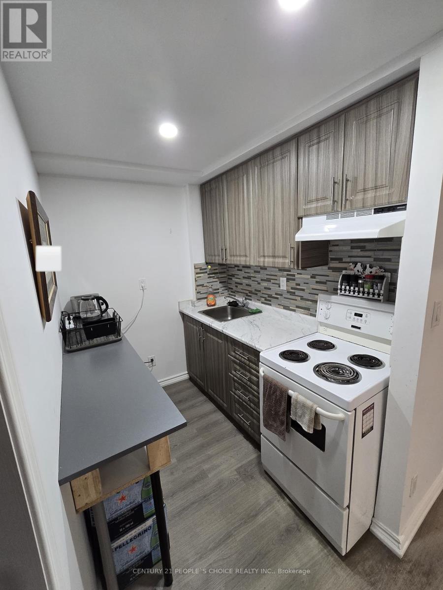 A modern kitchen with a stove top oven and a range hood.