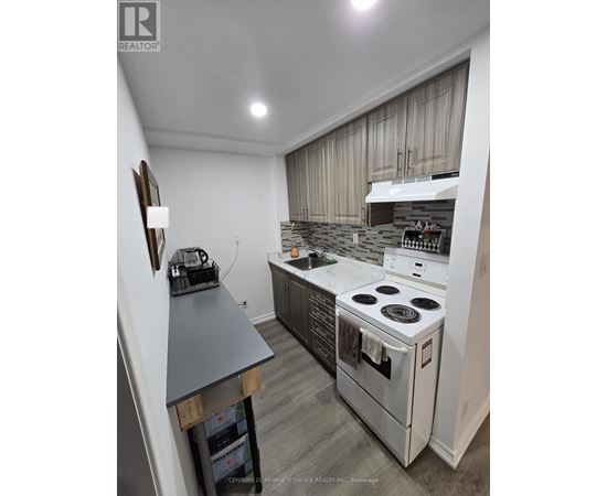 A modern kitchen with a stove top oven and a range hood.