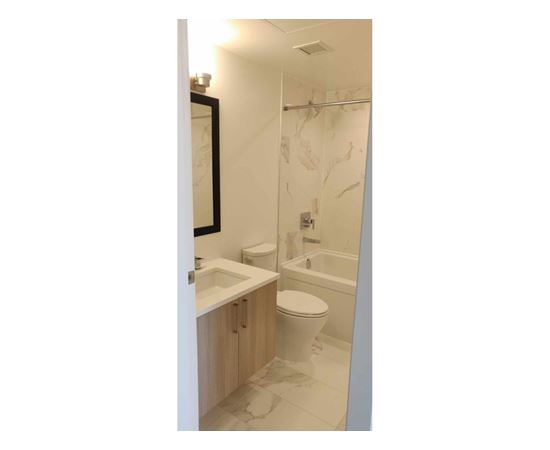A bathroom with a toilet, sink, and shower.