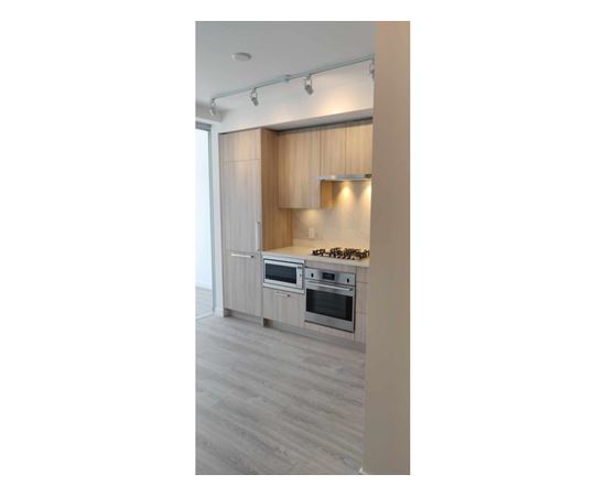 A kitchen with a stove top oven and a microwave.