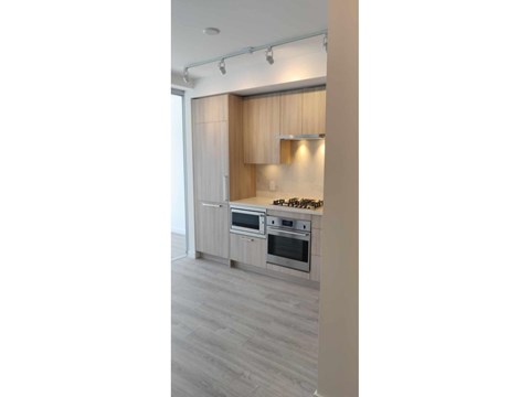 A kitchen with a stove top oven and a microwave.