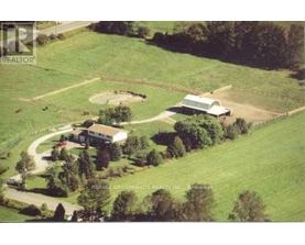 A farm with a barn and a house is shown in the image.