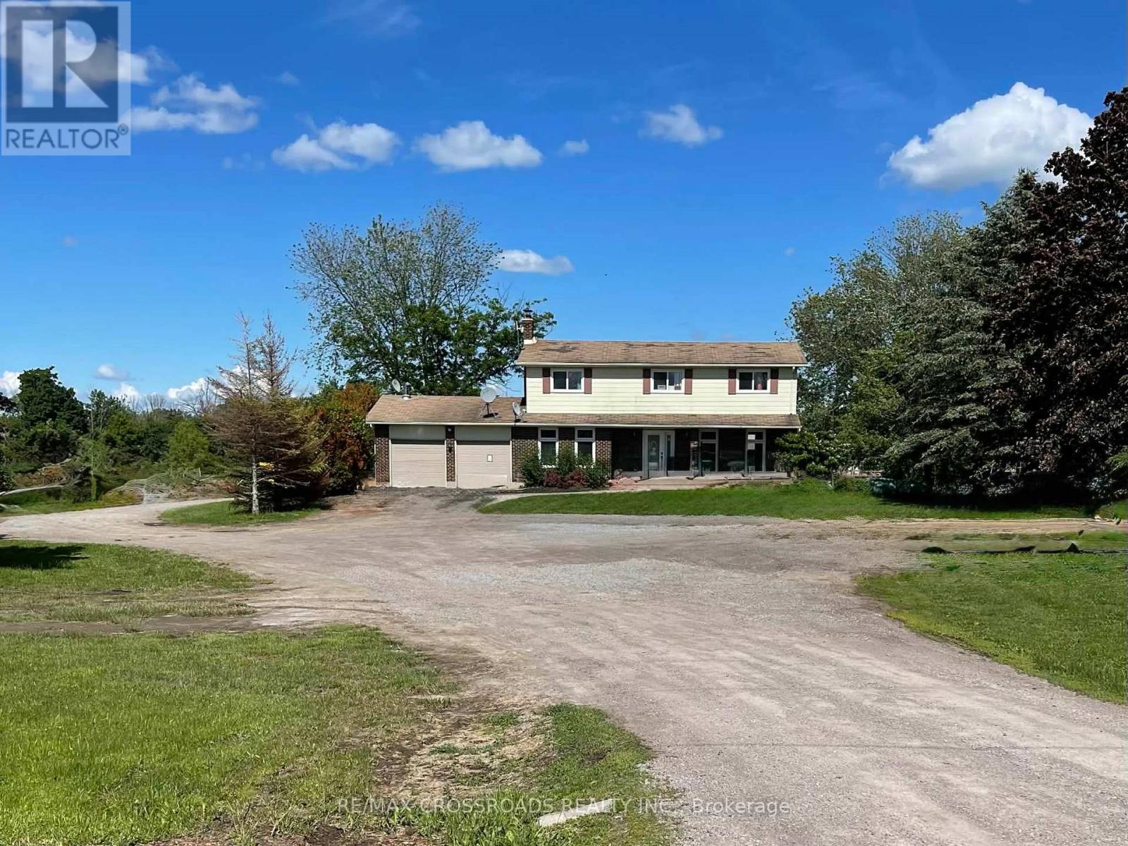 A large house with a driveway in front of it.