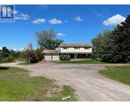 A large house with a driveway in front of it.
