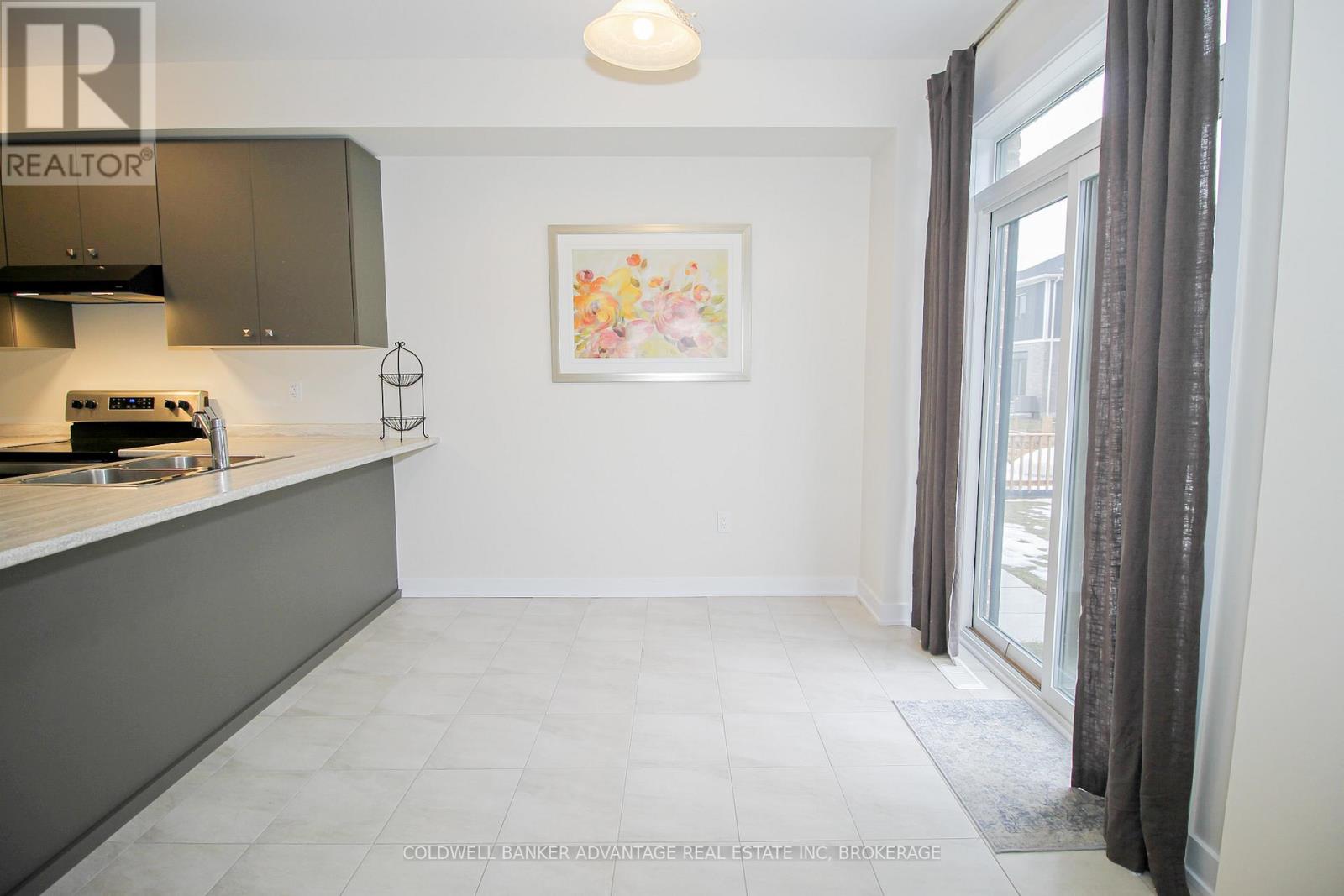 A kitchen area with a stove and a fridge.