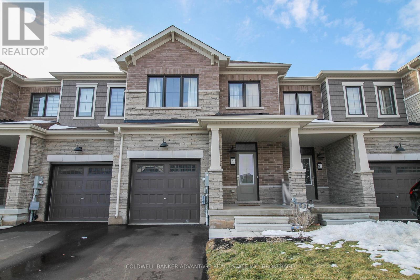 A large, multi-level house with a garage is for sale.