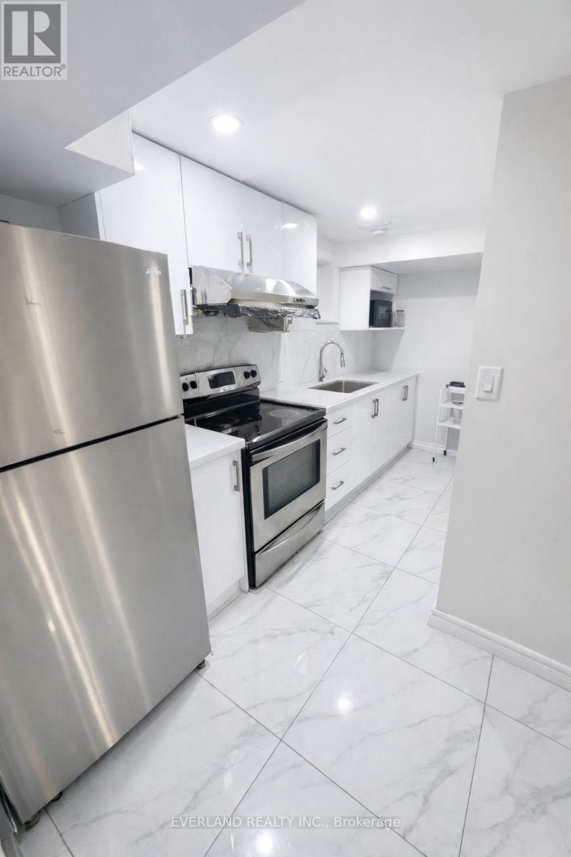 A modern kitchen with a stainless steel refrigerator.