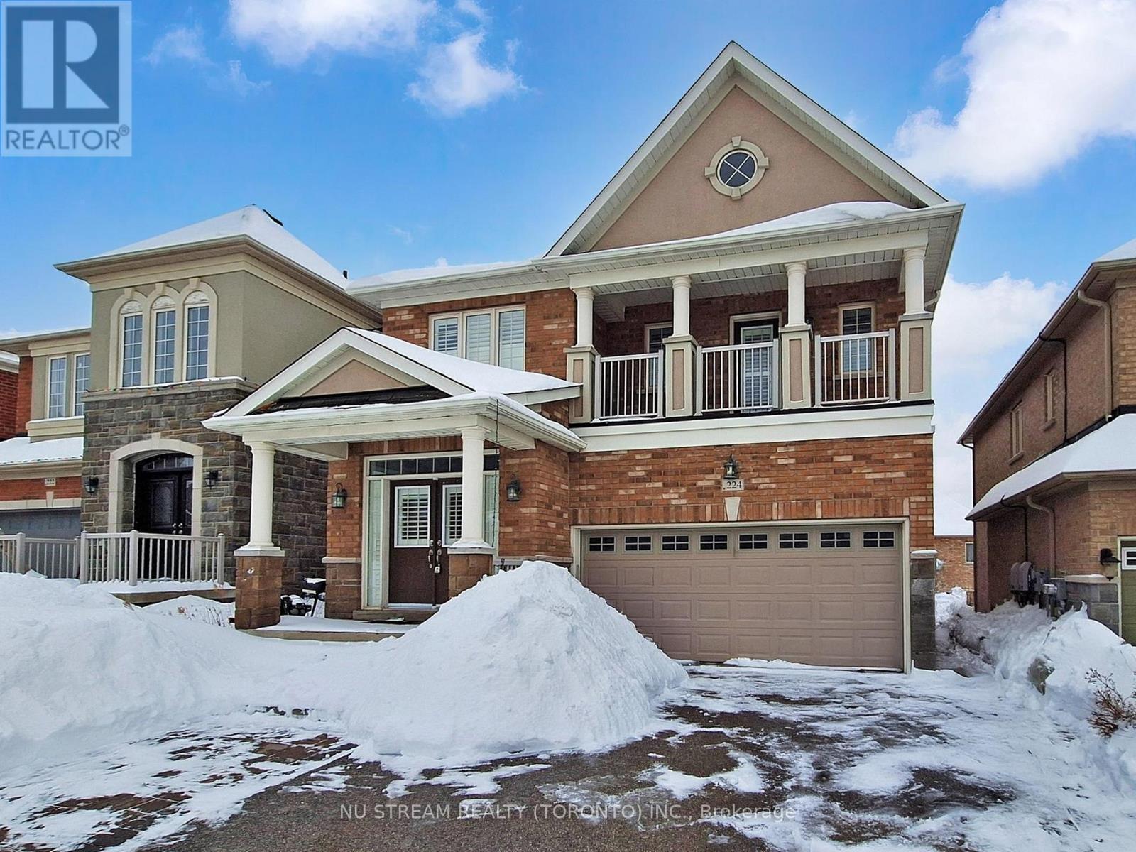 A house with a snow-covered front yard.