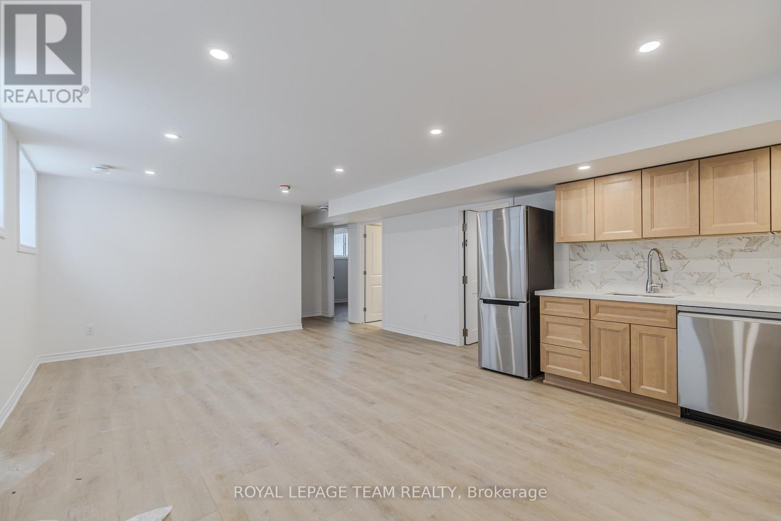 A spacious kitchen with wooden cabinets and stainless steel appliances.