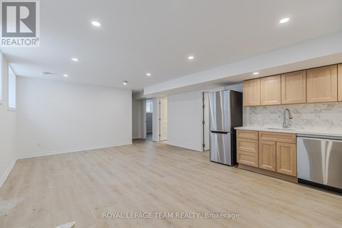 A spacious kitchen with wooden cabinets and stainless steel appliances.