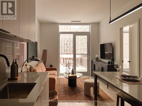 A modern kitchen with a dining area and a living room with a couch and a chair.