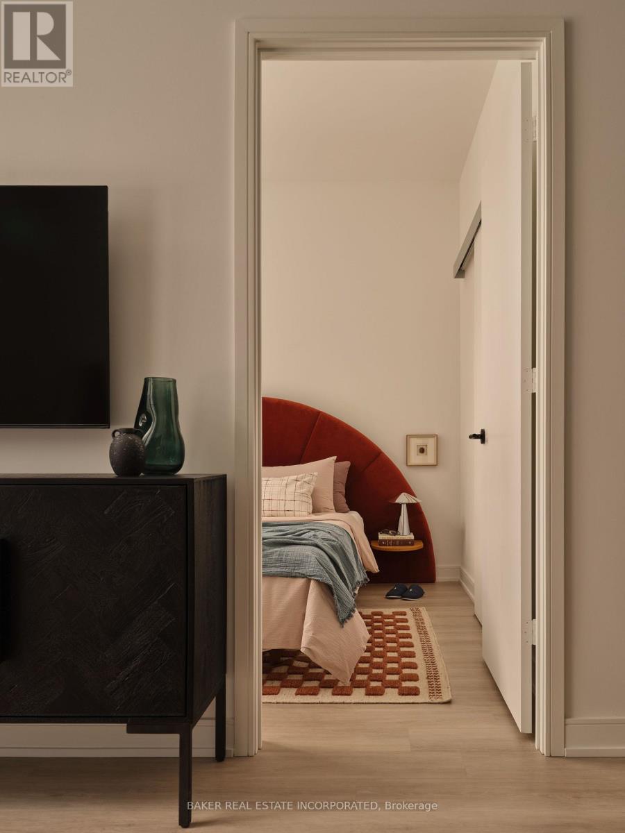 A bedroom with a bed, a chair, and a television.