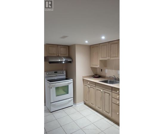 A white stove and oven in a kitchen with beige cabinets.