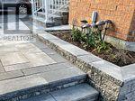 A brick building with a stone walkway in front.
