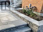 A brick building with a stone walkway in front.