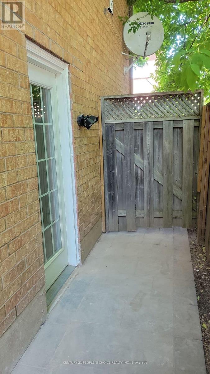 A wooden gate leads to a backyard.