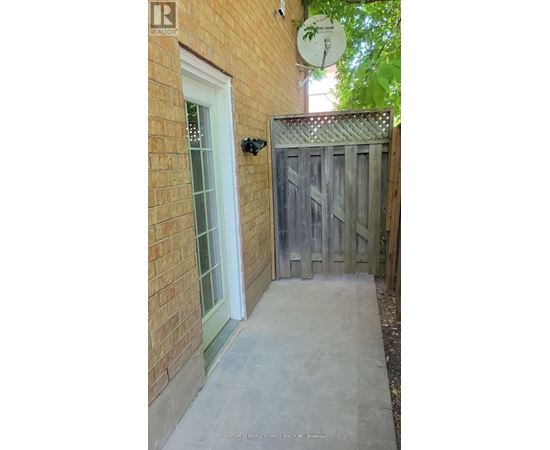A wooden gate leads to a backyard.