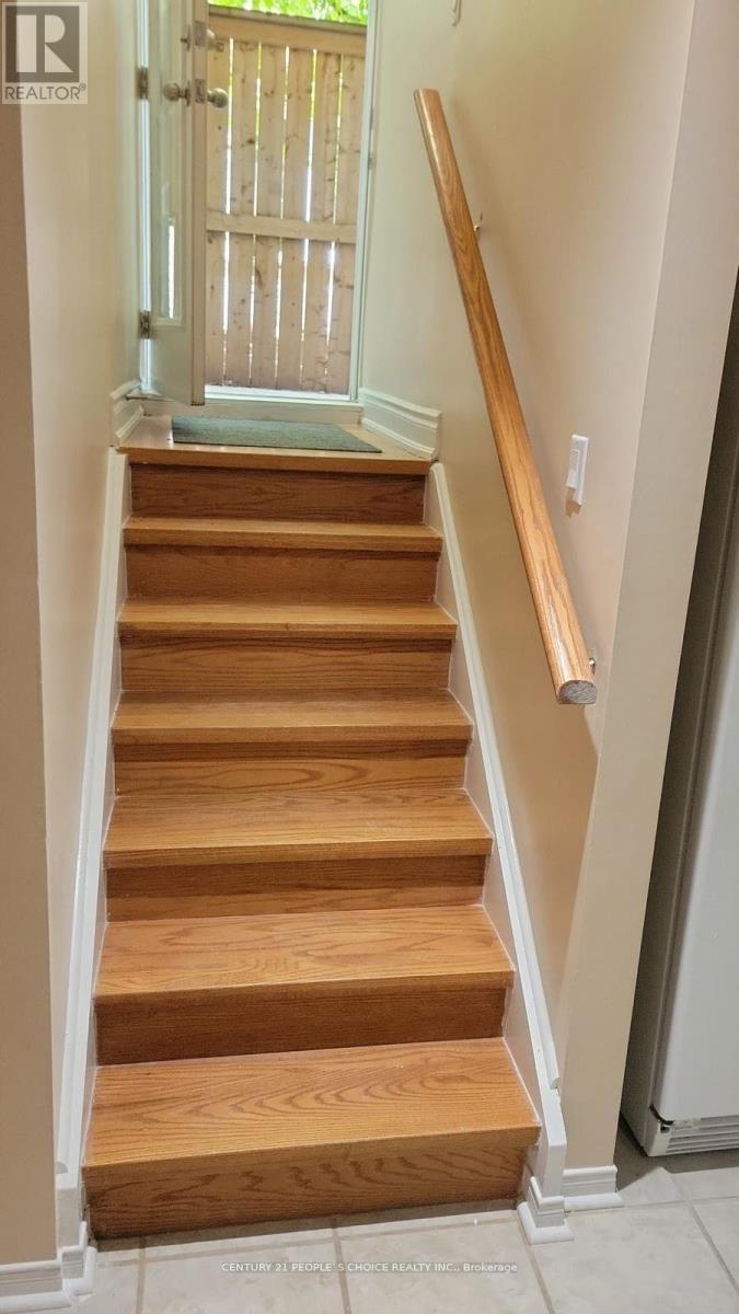 A wooden staircase with a white railing.