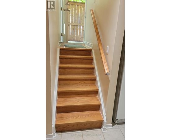 A wooden staircase with a white railing.