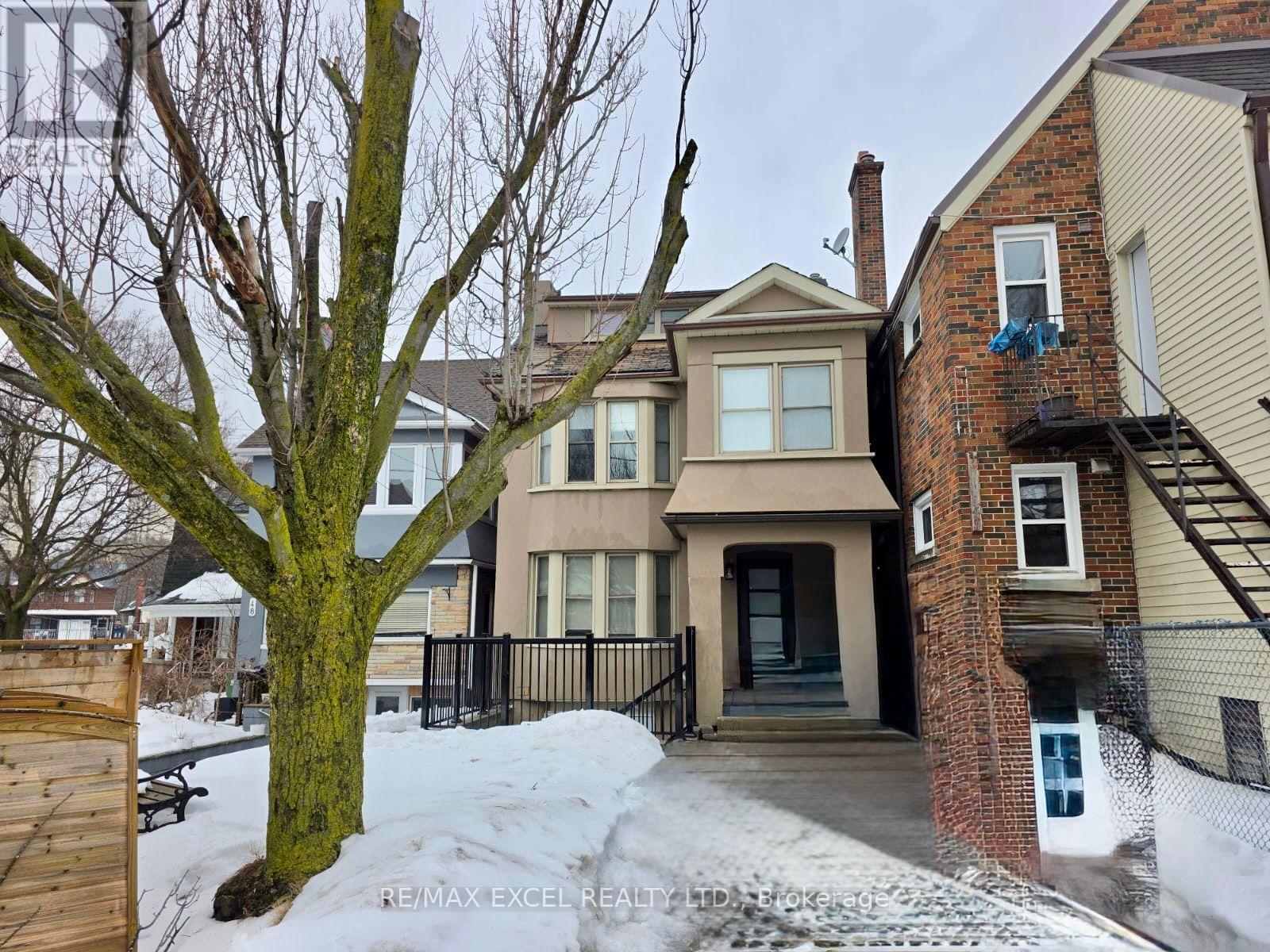 A house with a tree in front of it.