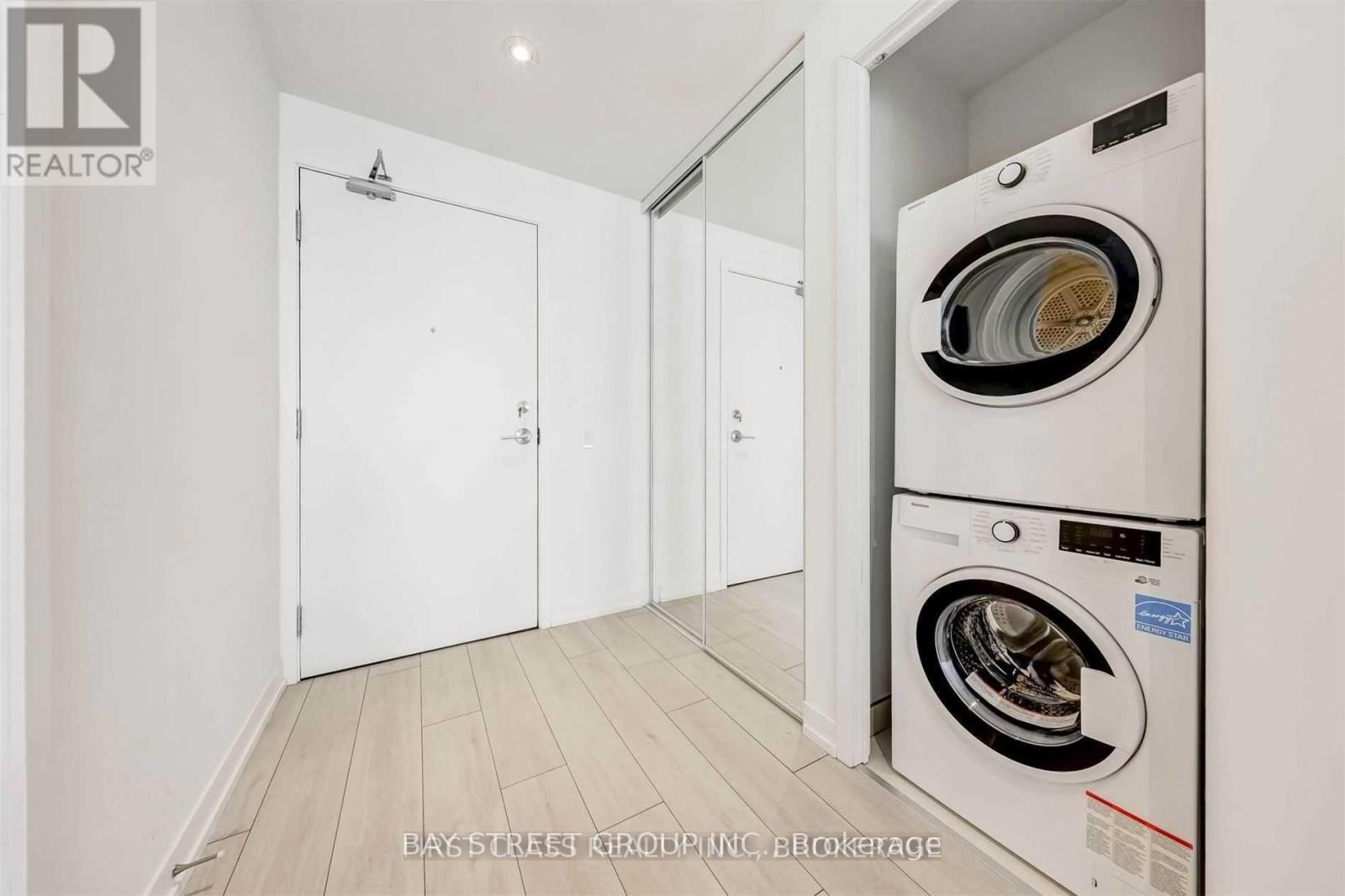 A white washing machine is in a small laundry room.