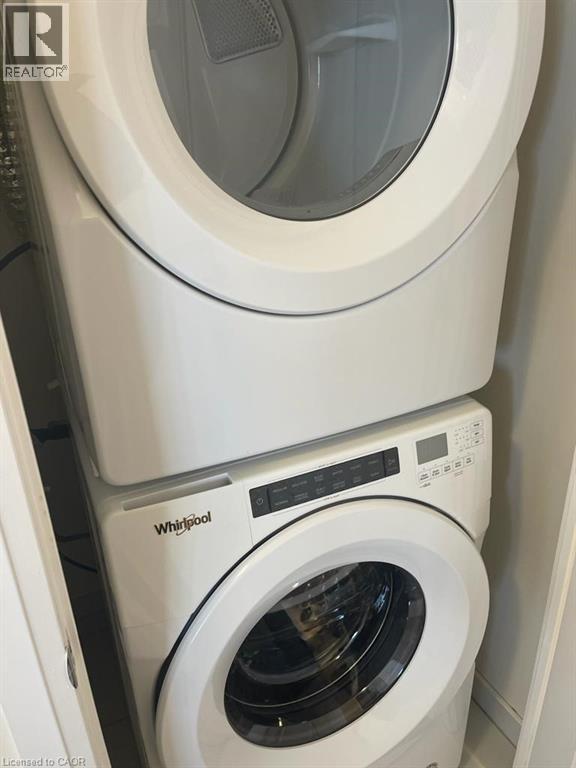 A white Whirlpool washing machine and dryer stacked on top of each other.