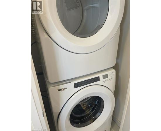 A white Whirlpool washing machine and dryer stacked on top of each other.
