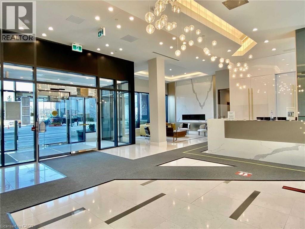 A spacious lobby with a reception desk and a glass door entrance.