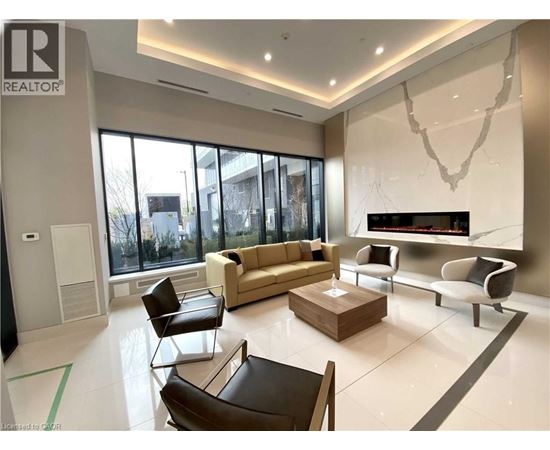 A living room with a brown leather chair and a white couch.