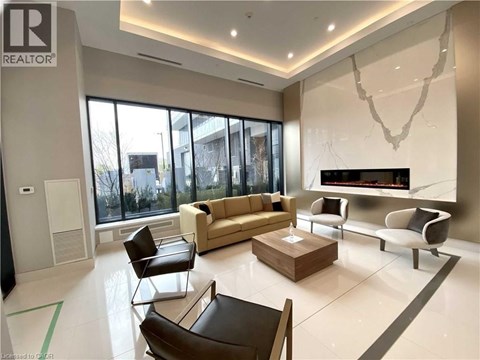 A living room with a brown leather chair and a white couch.