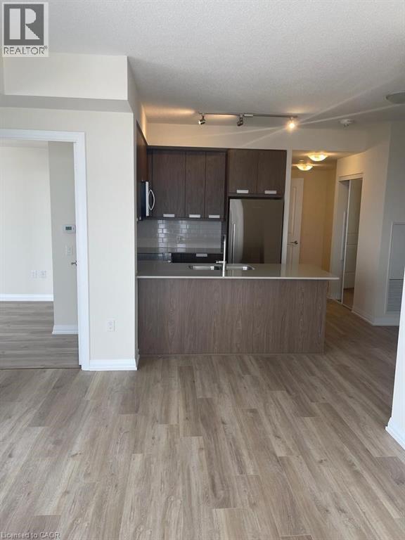 A kitchen with wooden cabinets and a countertop.