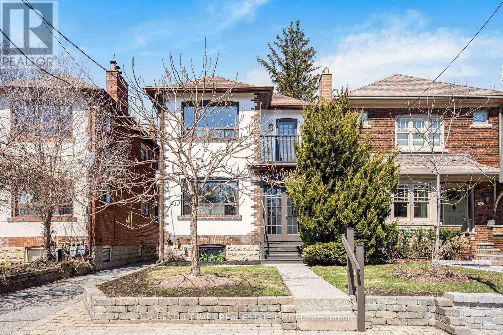 A house with a brick facade and a large front yard.