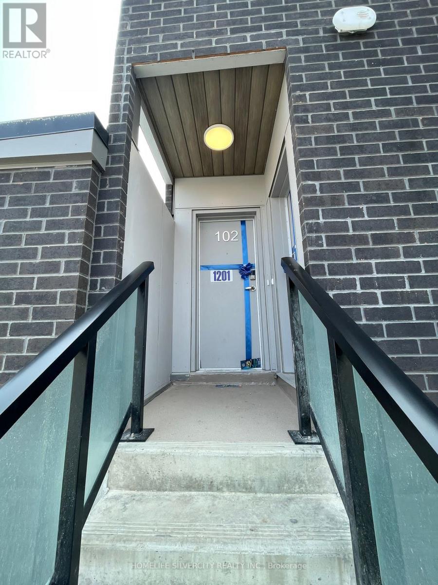 A set of stairs leading to a door with a number 102 on it.