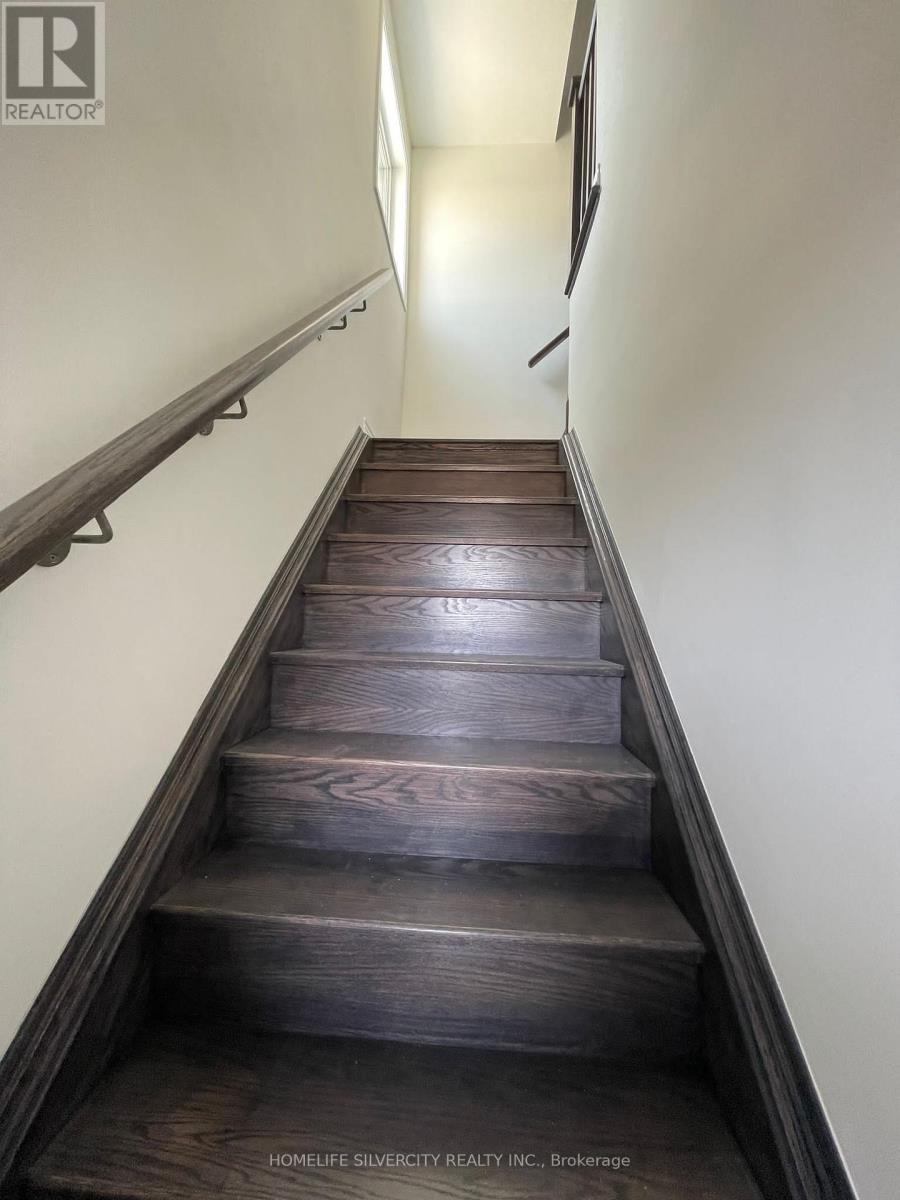A set of stairs with wooden steps and a metal handrail.