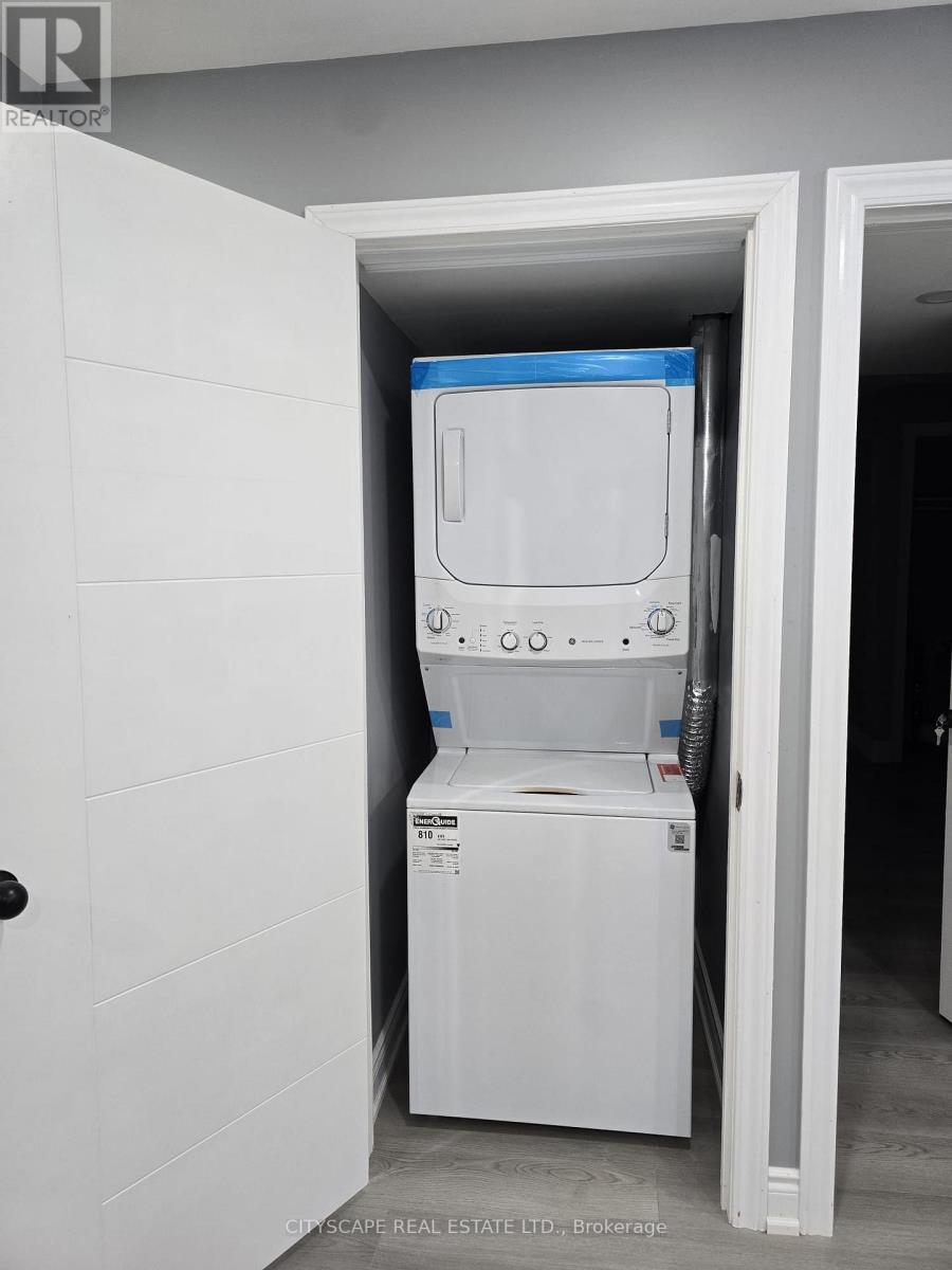 A white refrigerator is installed in a narrow space between two walls.